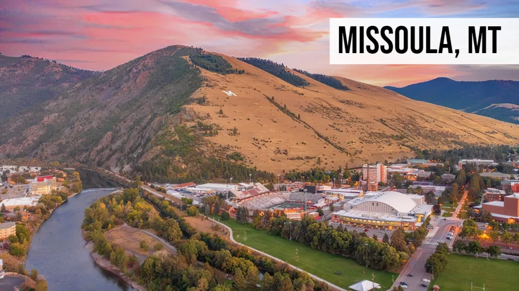 Missoula, Montana aerial view of downtown with riverfront, university area, and surrounding mountains