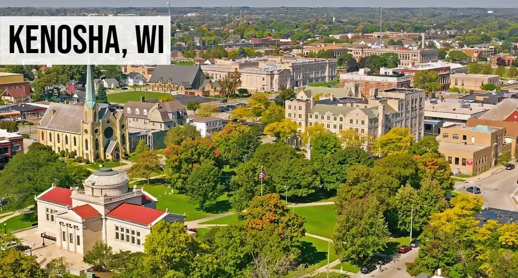 Kenosha, Wisconsin aerial view of downtown area with historic buildings, streets, trees, and surrounding city