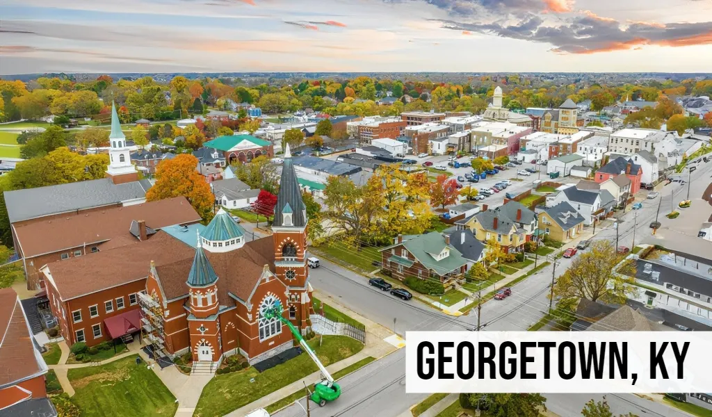 Land Buyers in Kentucky – Georgetown, KY Georgetown, Kentucky aerial view of downtown with historic buildings, church steeples, streets, and surrounding town