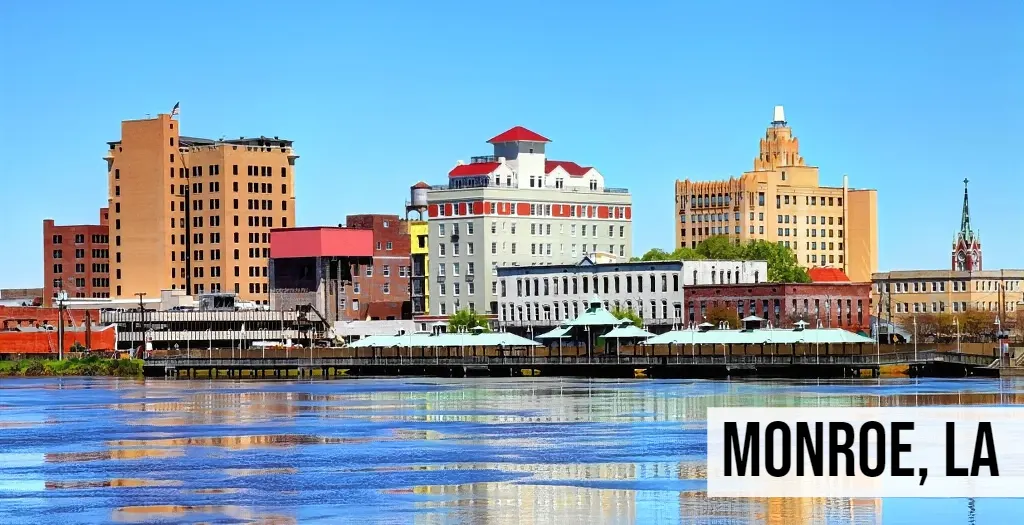 Monroe, Louisiana riverfront skyline with downtown buildings, waterfront structures, and surrounding city area