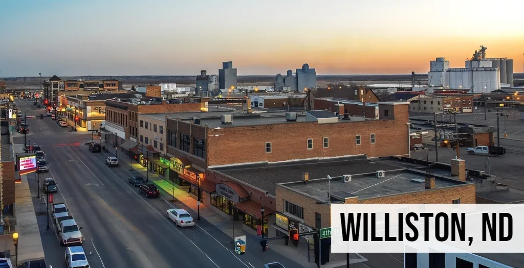 Williston, North Dakota downtown street view with main road, storefronts, and surrounding city blocks