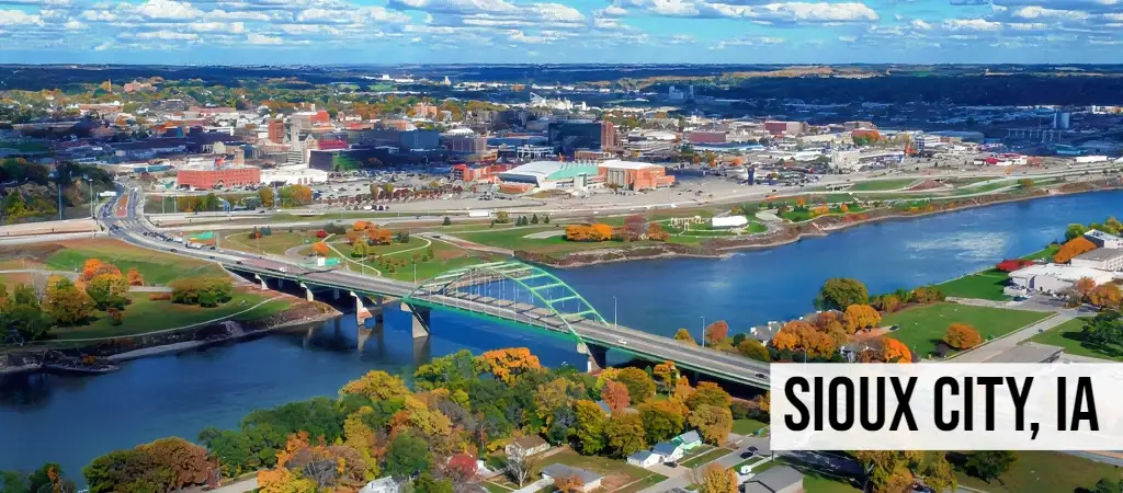 Sell My Land Iowa – Sioux City, IA Sioux City, Iowa aerial view of downtown with river crossing and surrounding city development