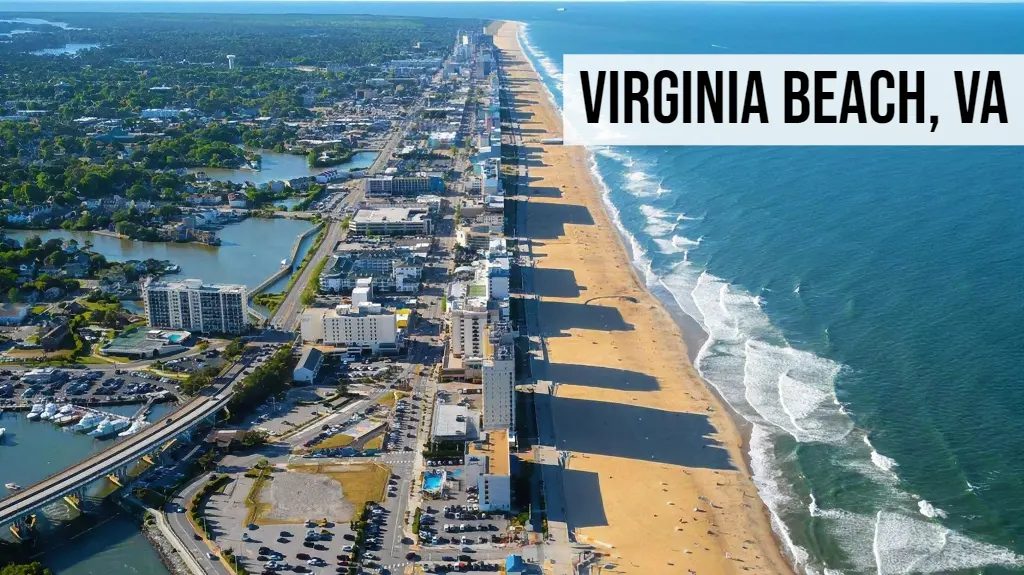 Virginia Beach, Virginia aerial view of oceanfront with sandy beach, boardwalk, hotels, residential neighborhoods, and Atlantic coastline