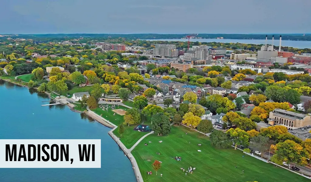 Madison, Wisconsin aerial view of lakeside city with shoreline, green space, buildings, and surrounding urban area