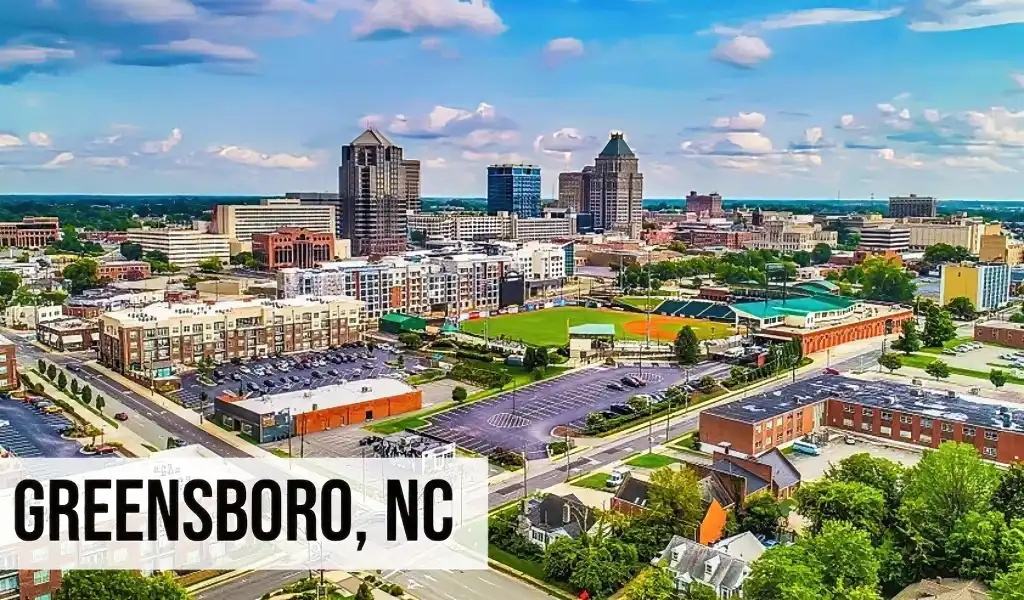 Greensboro, North Carolina aerial view of downtown with office buildings, streets, parking areas, and surrounding neighborhoods