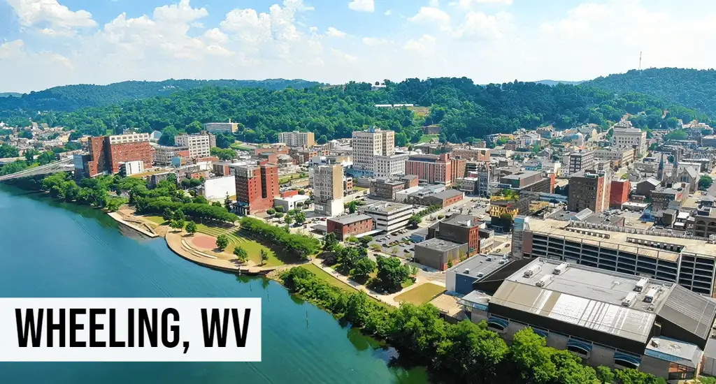 Wheeling, West Virginia aerial view of downtown along the river with bridges, buildings, and surrounding development