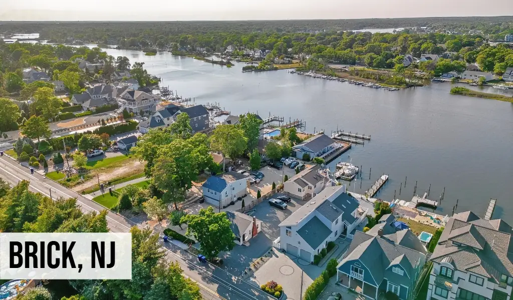 Brick, New Jersey aerial view of residential neighborhood along river with homes, docks, waterway, and surrounding area