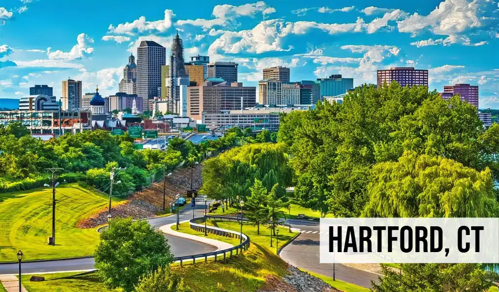 Hartford, Connecticut city skyline view with park space, riverfront, buildings, and surrounding urban area