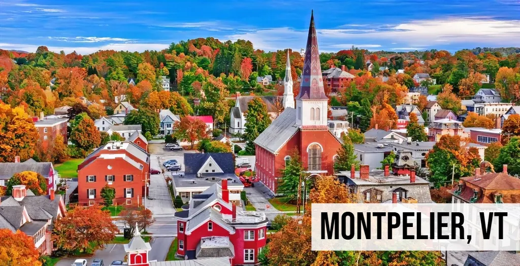 Montpelier, Vermont aerial view of downtown with church steeples, fall foliage, residential buildings, and streets