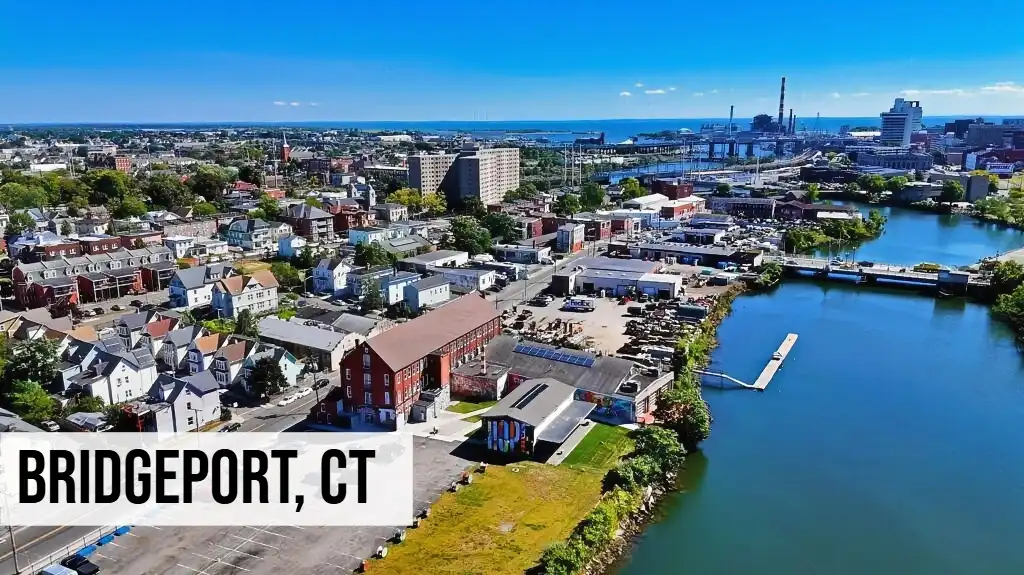 Bridgeport, Connecticut aerial view of downtown waterfront with buildings, marina, river, and surrounding city