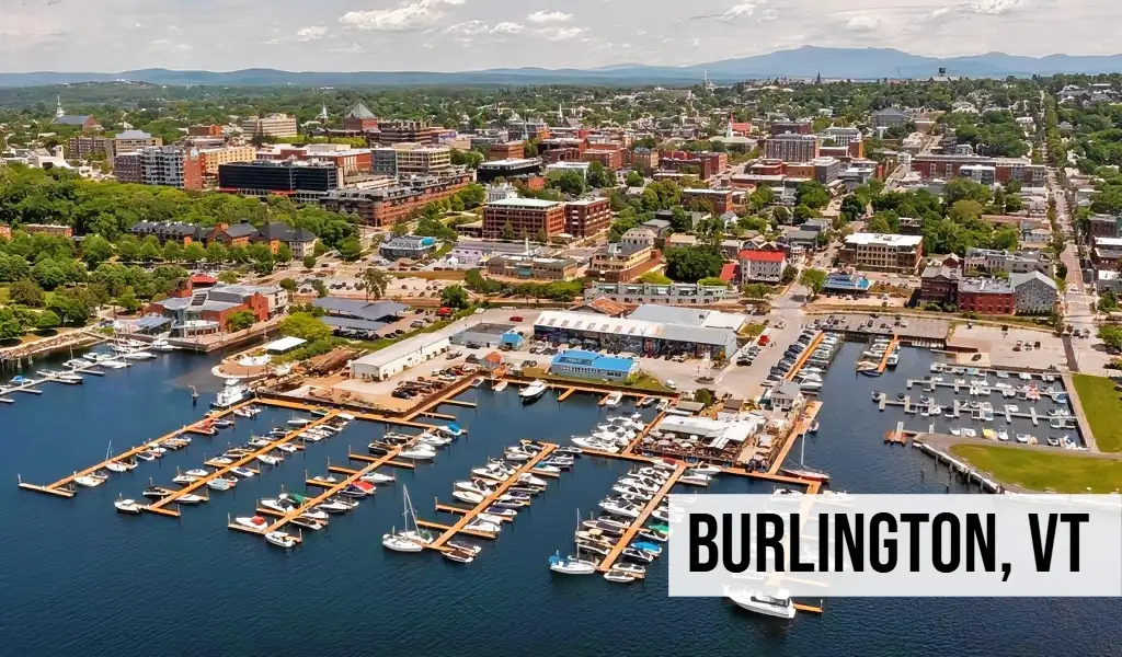 Burlington, Vermont aerial view of downtown waterfront with marina, boats, Lake Champlain, and surrounding city