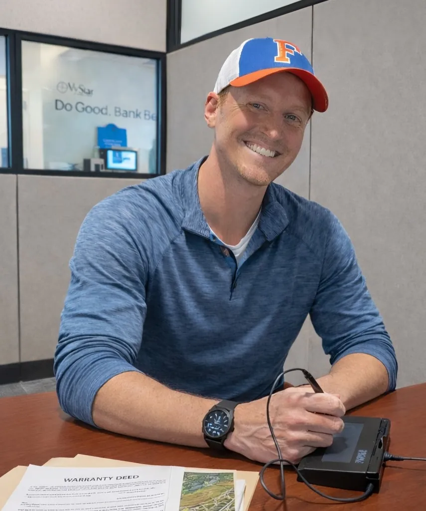 Bubba Peek signing closing docs in Florida.